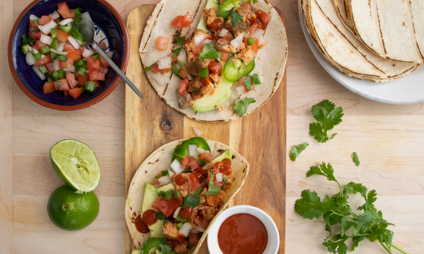 Top view of Fish Tacos with Salmon and Pico de Gallo on a wooden board